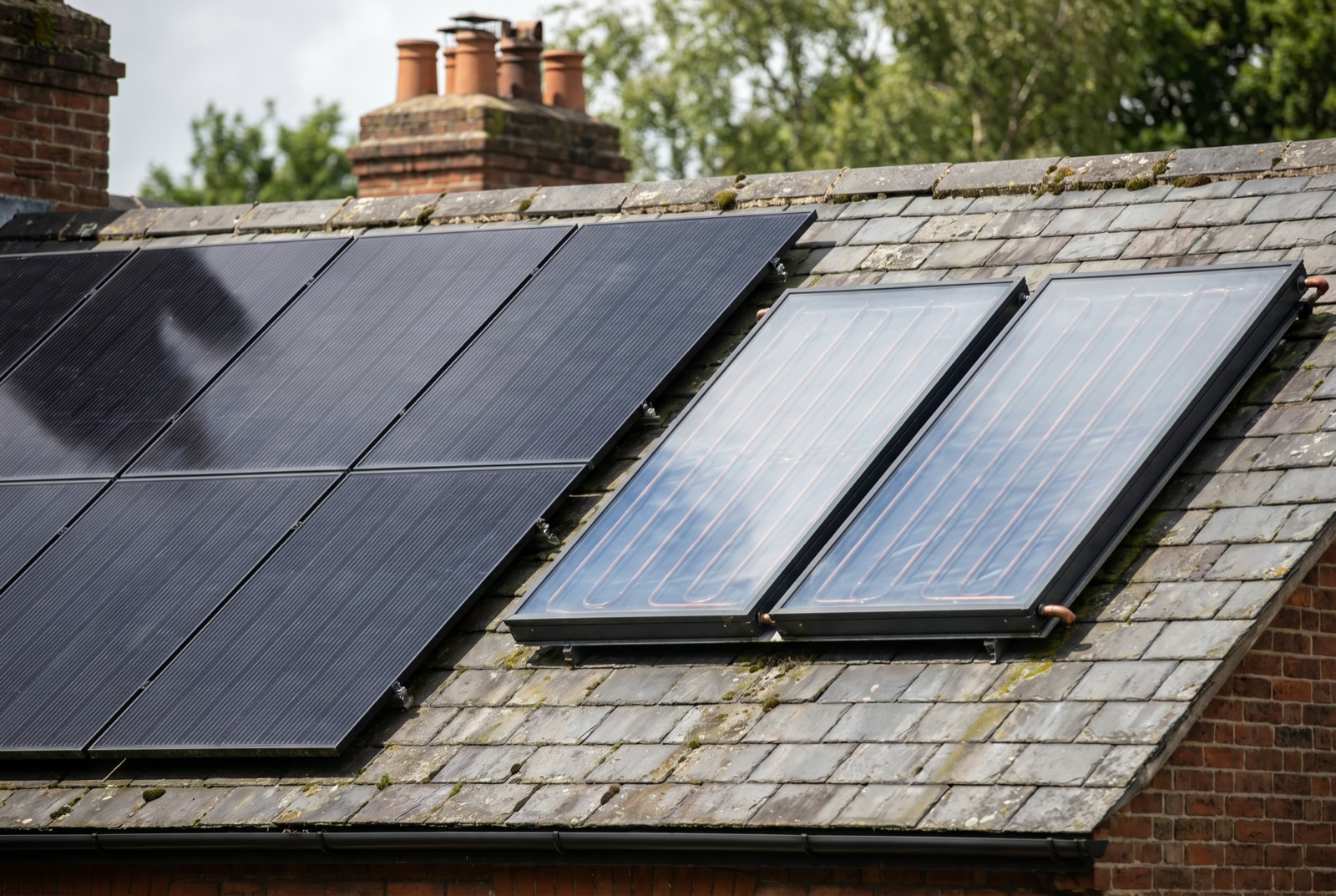 A UK roof with both solar PV panels and solar thermal collectors side by side
